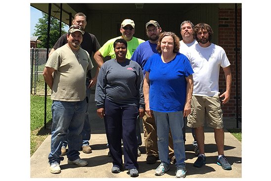 Gerald Andrus volunteers made home  improvements for a local resident (in blue shirt) as part of a  United Way community initiative. 